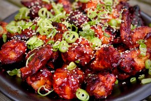 Normal - Korean Chicken – Version 4 photo of Korean Chicken Wings garnished with spring onions on a plate