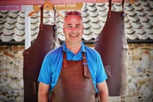 Phot of Nic wearing the Meat Smoke Fire Leather Apron