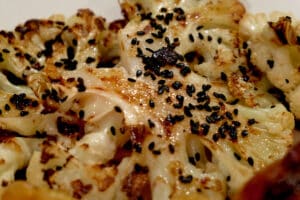 close up photo of Cauliflower steaks with dressing