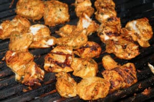 photo of Chicken Tikka pieces on a bbq grill