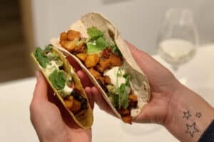 photo of two Butternut Squash Tacos held in two hands