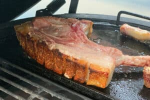 photo of Crispy pork chops on a plancha on a bbq