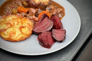 phot of Sweet and spicy beetroot as part of a meal on a grey plate