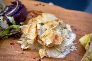 Celeriac and fennel gratin photo of a portion of Celeriac and fennel gratin on a board