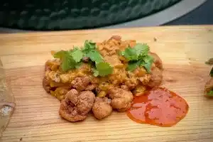 Chicken 65 a photo of Chicken 65 garnished with coriander on a board