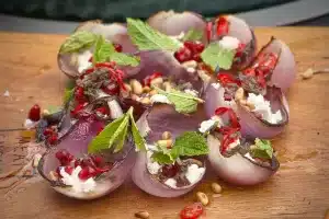 photo of Charred onion baskets with pomegranate, feta, and pine nuts