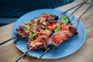 photo of three Thai sesame skewers on a grey plate