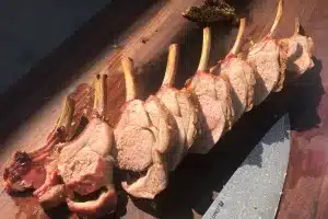 Photo of Rack of lamb sliced on a board