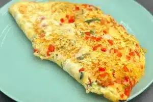 photo of Parsi Omelette folded in half on a green plate