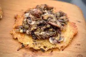 photo of Potato rosti with mushroom and onion on a board