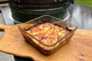 Celariac and turnip gratin in a dish on a board