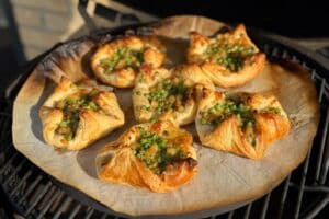 photo of six Pea and potato galettes on a baking stone in a bbq