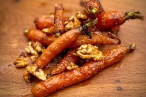 photo of Carrots with candied walnuts on a board