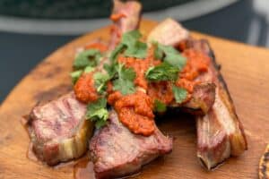 Lamb Cutlets with Rojo Sauce on a board