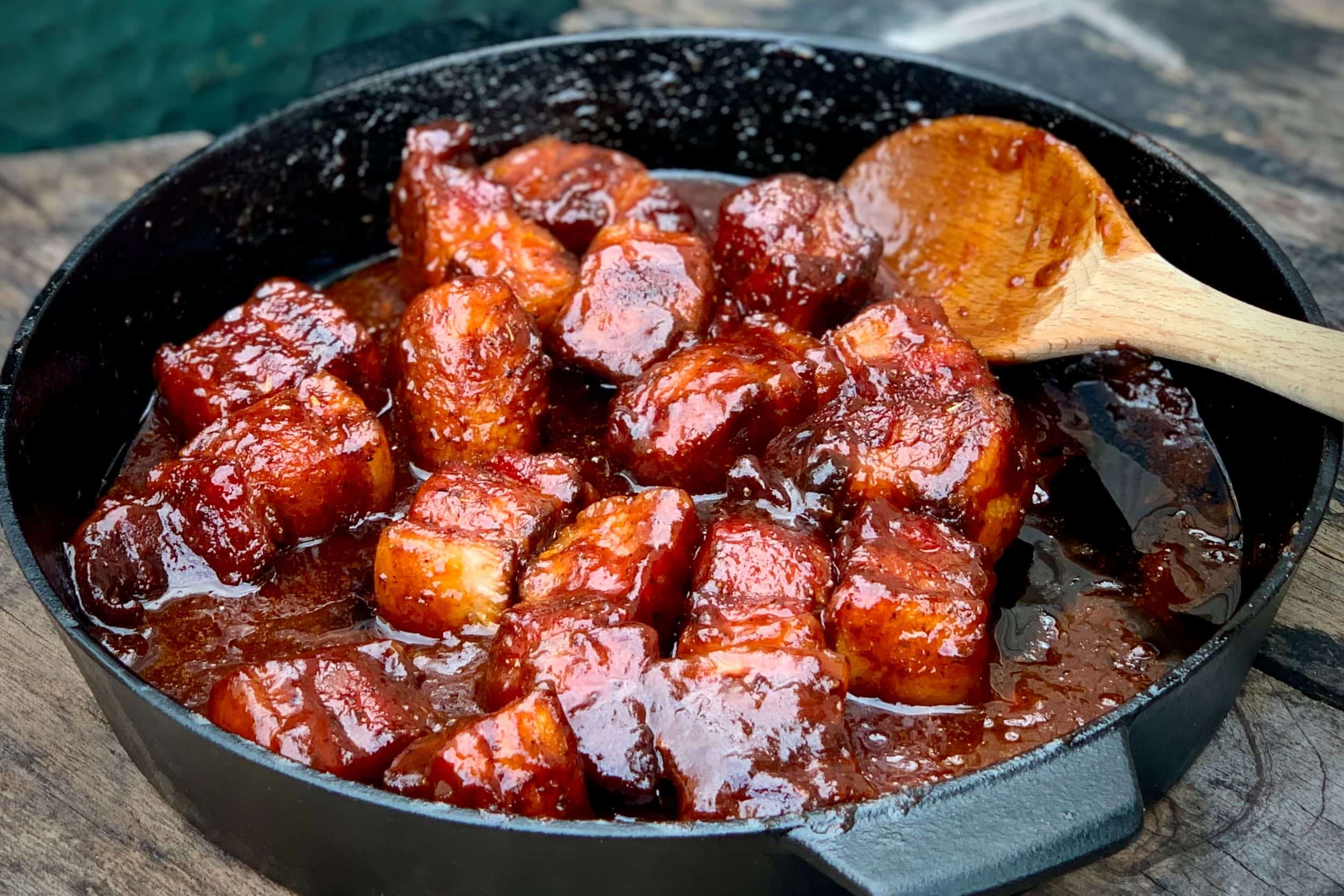 A photo of Pork Belly Burnt Ends in a small Big Green Egg Cast Iron Skillet